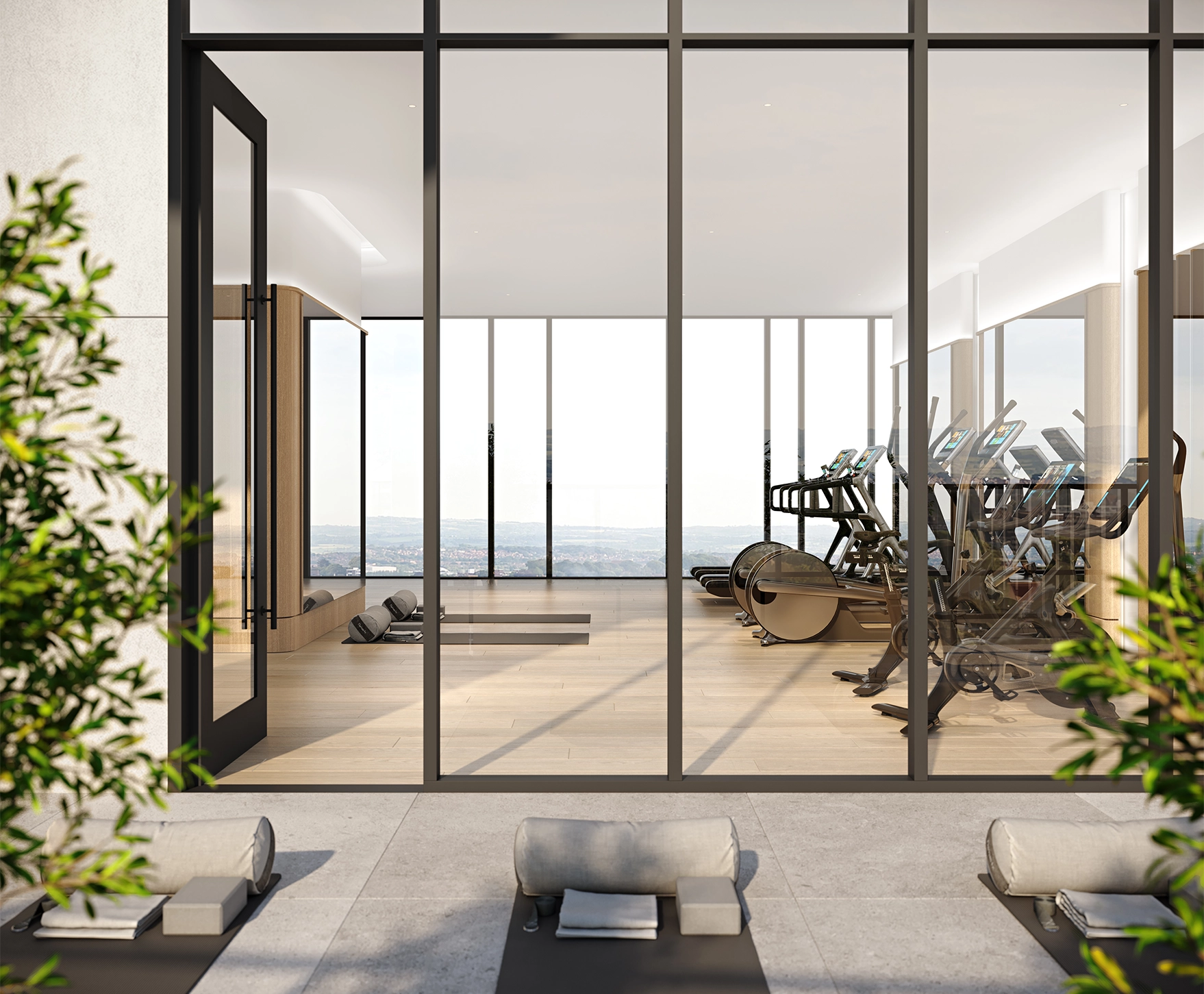 Bright and airy boutique hotel fitness centre with premium hardwood flooring and high-end exercise machines at The Glenhill Hotel, North York