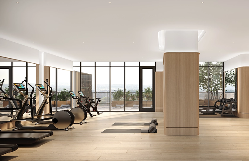 Bright natural light through large floor to ceiling windows at the boutique hotel gym with premium hardwood flooring and high-end exercise machines at the Glenhill Hotel, North York