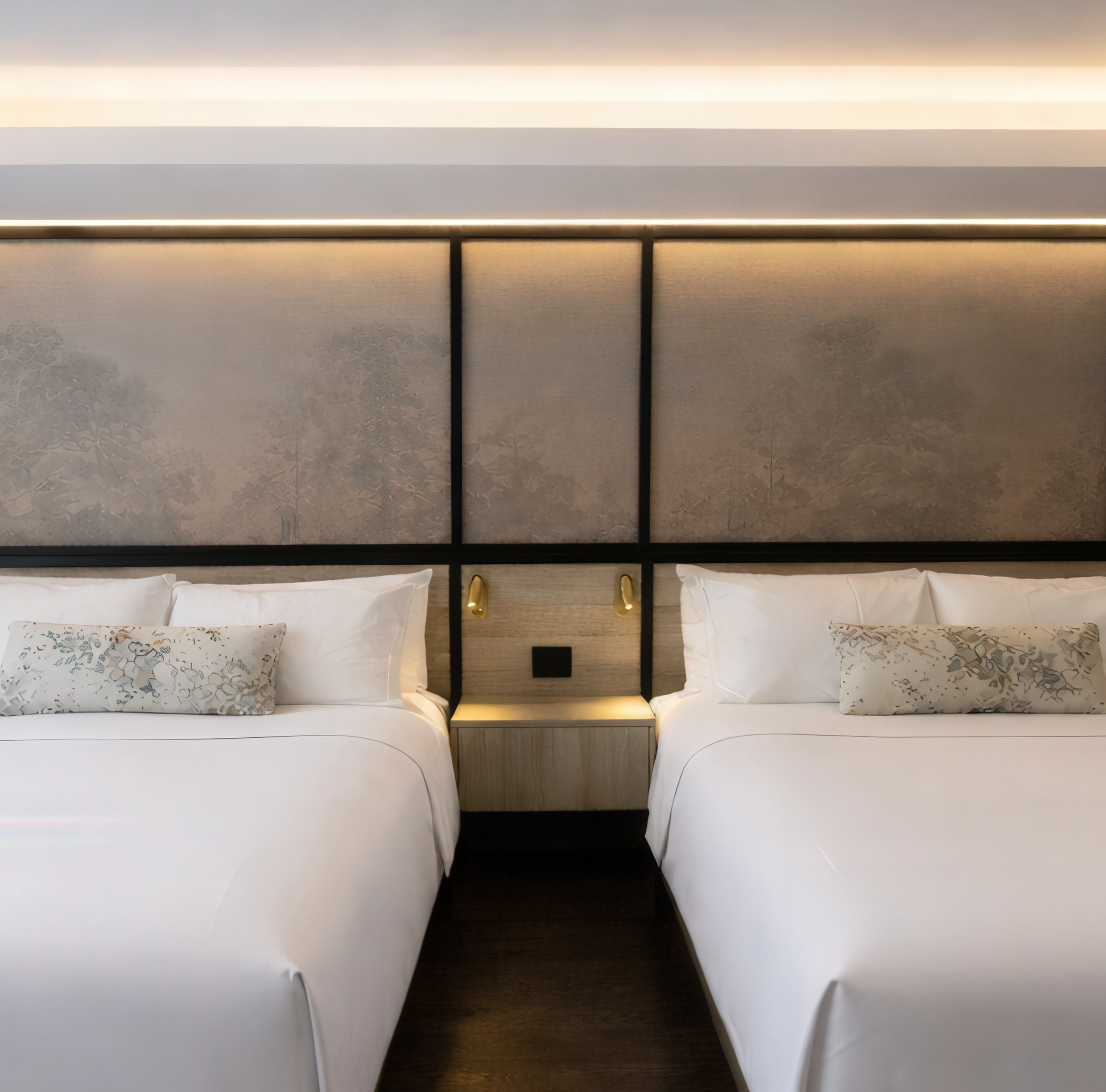 Luxury hotel suite at The Glenhill Hotel North York featuring two queen-size beds with premium white linens, high-end headboards, and elegant boutique finishes